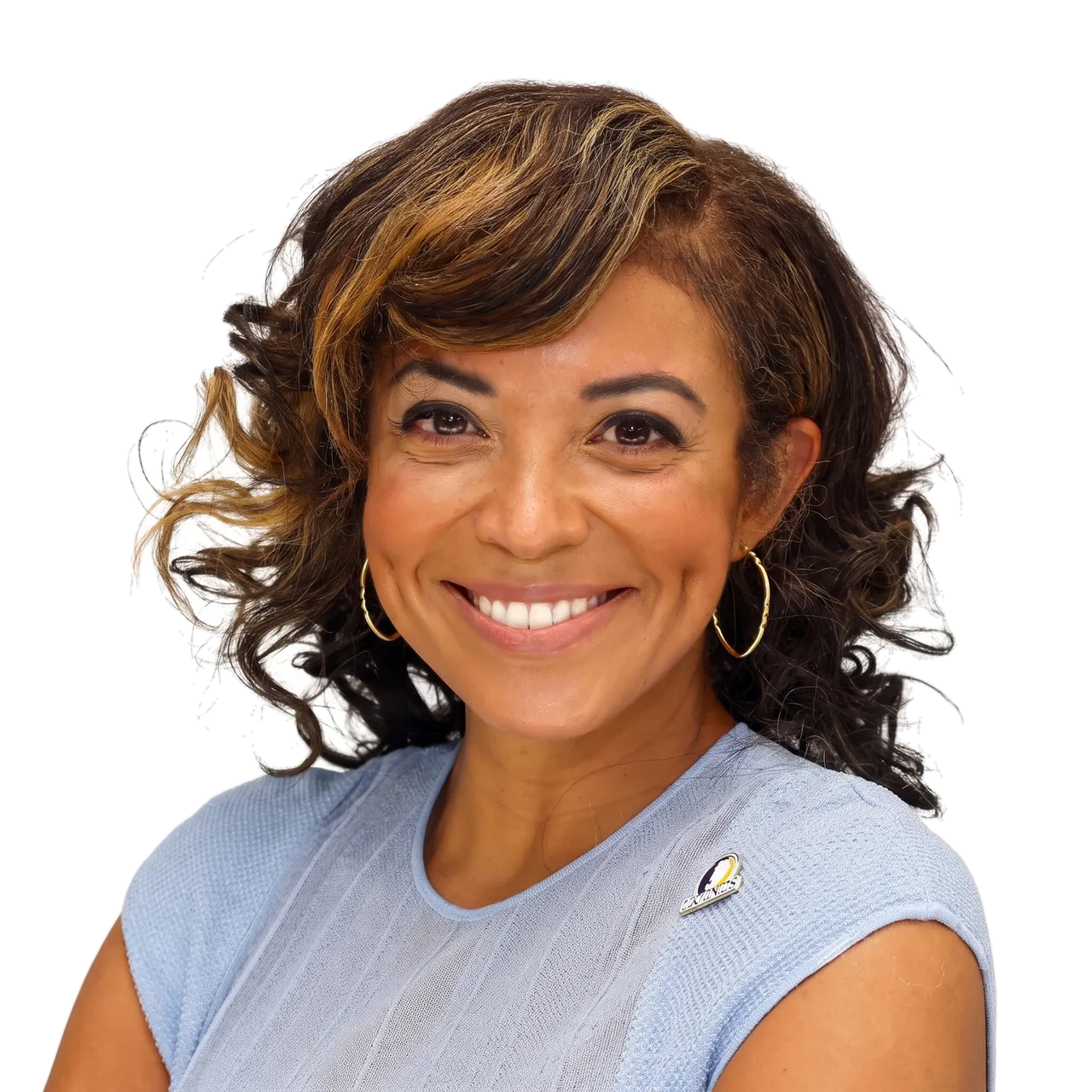Atasha M. James, smiling warmly in a light blue knit top and gold hoop earrings